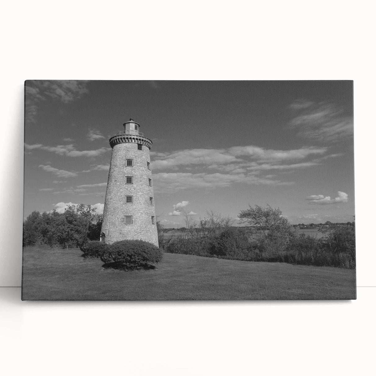 Stretched canvas wall art featuring a serene coastal landscape with a lighthouse, vibrant colors of blue and green, ideal for enhancing home decor.