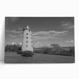 Stretched canvas wall art featuring a serene coastal landscape with a lighthouse, vibrant colors of blue and green, ideal for enhancing home decor.