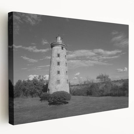 Stretched canvas wall art showcasing a picturesque lighthouse amidst serene landscapes, featuring vibrant colors and fine details, ideal for coastal-themed decor.