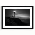 Framed wall art featuring a lighthouse design in a black frame with a mat, showcasing vibrant colors and intricate details, perfect for coastal-themed decor.