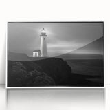 Framed acrylic wall art featuring a serene lighthouse design in a coastal landscape, highlighted by vibrant colors and a sleek white frame, ideal for home decor.
