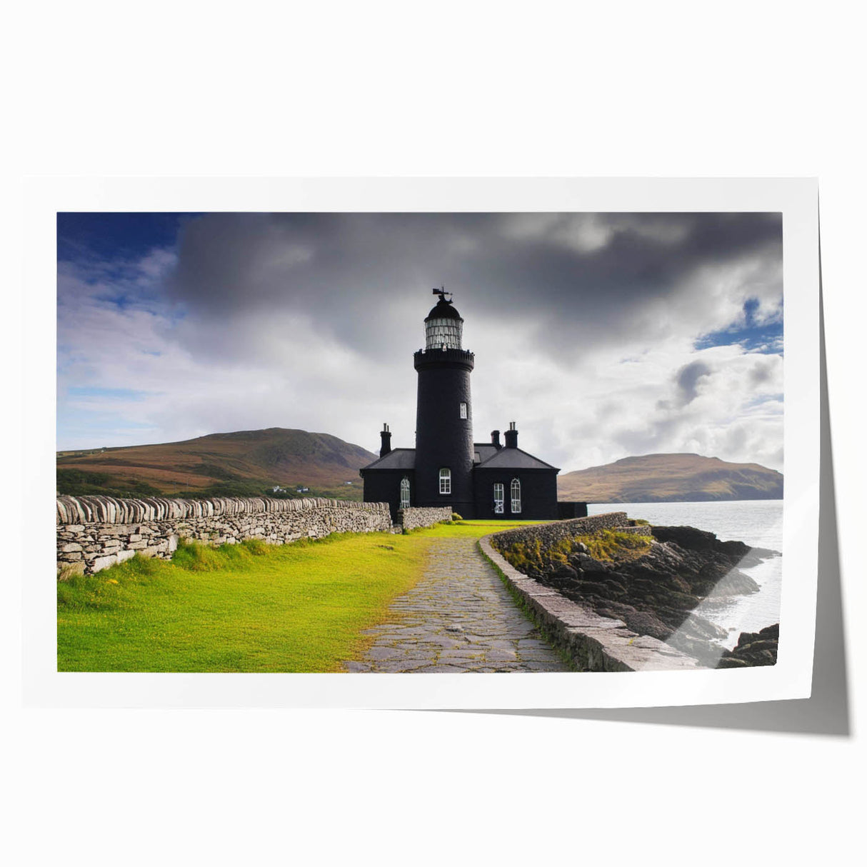 Lighthouse wall art print featuring a serene coastal landscape with waves crashing against rocky cliffs, showcasing vibrant colors and intricate details, rolled for easy shipping.