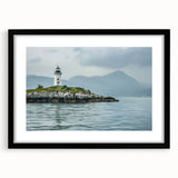 Framed wall art featuring a serene lighthouse landscape design, presented with a black mat and frame, ideal for coastal-themed home decor. Perfect for adding a touch of tranquility to living spaces.