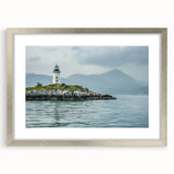 Silver-framed wall art featuring a scenic lighthouse landscape design with a mat, ideal for coastal-themed home decor. Perfect for enhancing living spaces with a touch of elegance and tranquility.