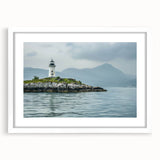 Framed wall art collection showcasing a serene lighthouse landscape design with a white mat and sleek frame, perfect for coastal-themed decor.