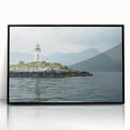 Framed wall art featuring a stunning lighthouse design set against a vibrant coastal landscape, with a sleek black frame enhancing its modern aesthetic. Perfect for nautical-themed decor or coastal living spaces.