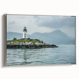 Framed canvas wall art showcasing a stunning silver-framed lighthouse design in a serene landscape, perfect for nautical-themed home decor.
