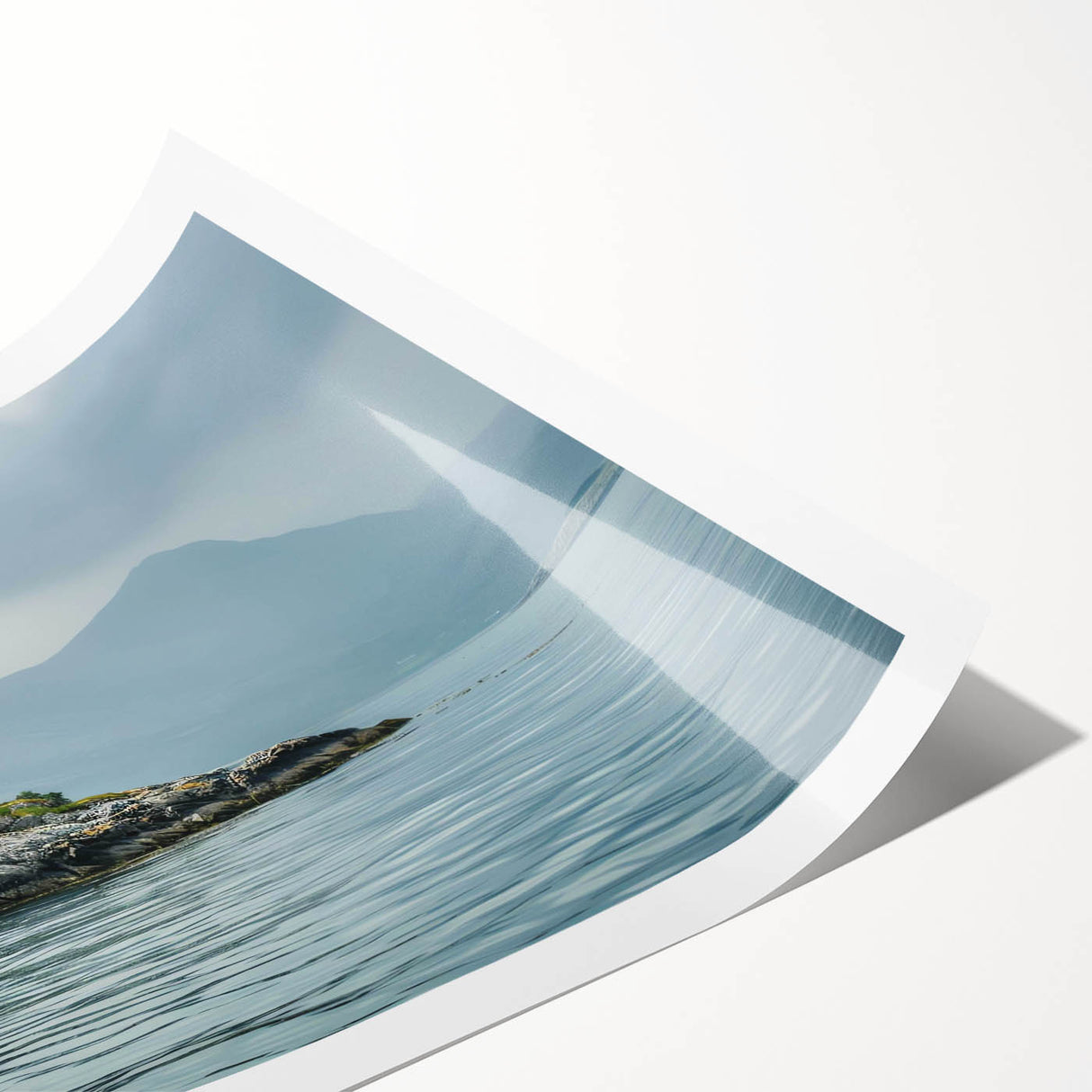 Rolled wall art print showcasing a serene lighthouse landscape design, featuring calming blues and greens, ideal for coastal decor, packaged securely for shipping.