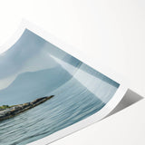 Rolled wall art print showcasing a serene lighthouse landscape design, featuring calming blues and greens, ideal for coastal decor, packaged securely for shipping.