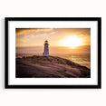 Framed wall art featuring a serene lighthouse landscape design with a black mat, perfect for coastal-themed decor, enhancing any living space ambiance.