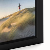 Close-up of a framed canvas wall art piece depicting a serene lighthouse landscape, featuring vibrant colors and intricate details, perfect for coastal home decor.