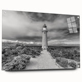 Close-up of a modern acrylic wall art collection featuring a vibrant lighthouse landscape design, set against a clear glass background, elegantly displayed with decorative pins.