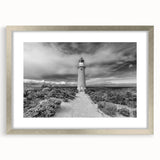 Silver-framed wall art collection featuring stunning landscapes and a lighthouse design, elegantly matted for enhanced visual appeal, perfect for home decor.