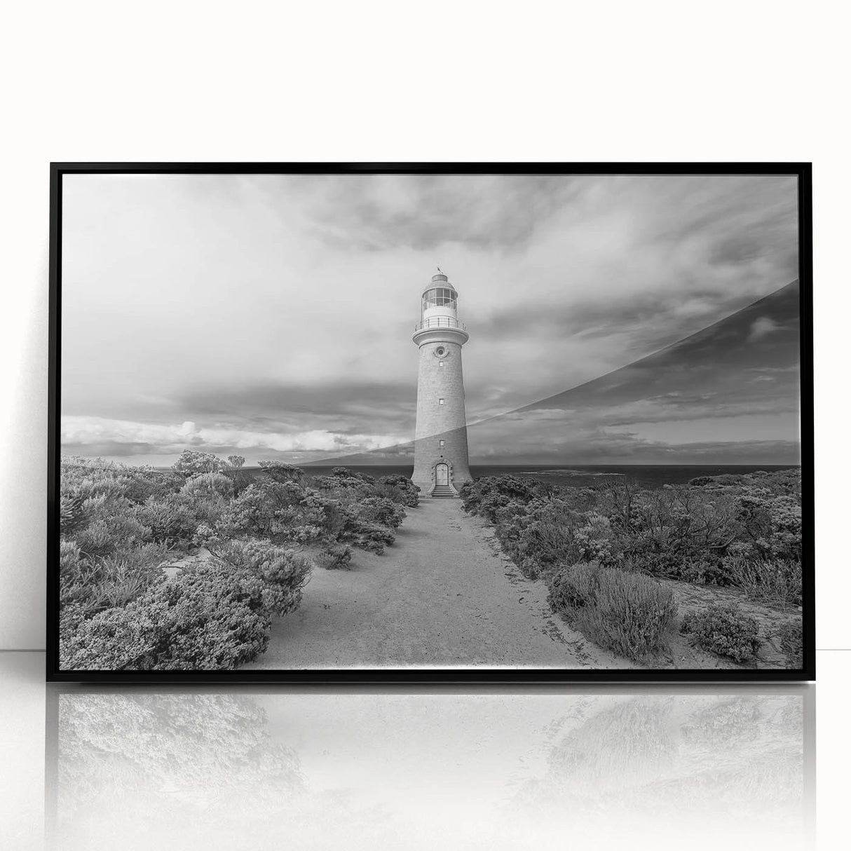 Framed acrylic wall art collection showcasing a scenic lighthouse design, with a sleek black frame and clear front view, perfect for coastal-themed decor.