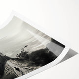 Rolled print showcasing a serene landscape featuring a lighthouse against a vibrant sunset. The artwork is ideal for coastal home decor, adding a tranquil ambiance.