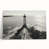 Stretched canvas wall art showcasing a serene coastal landscape with a lighthouse, vibrant sky, and tranquil water reflections, perfect for home decor.
