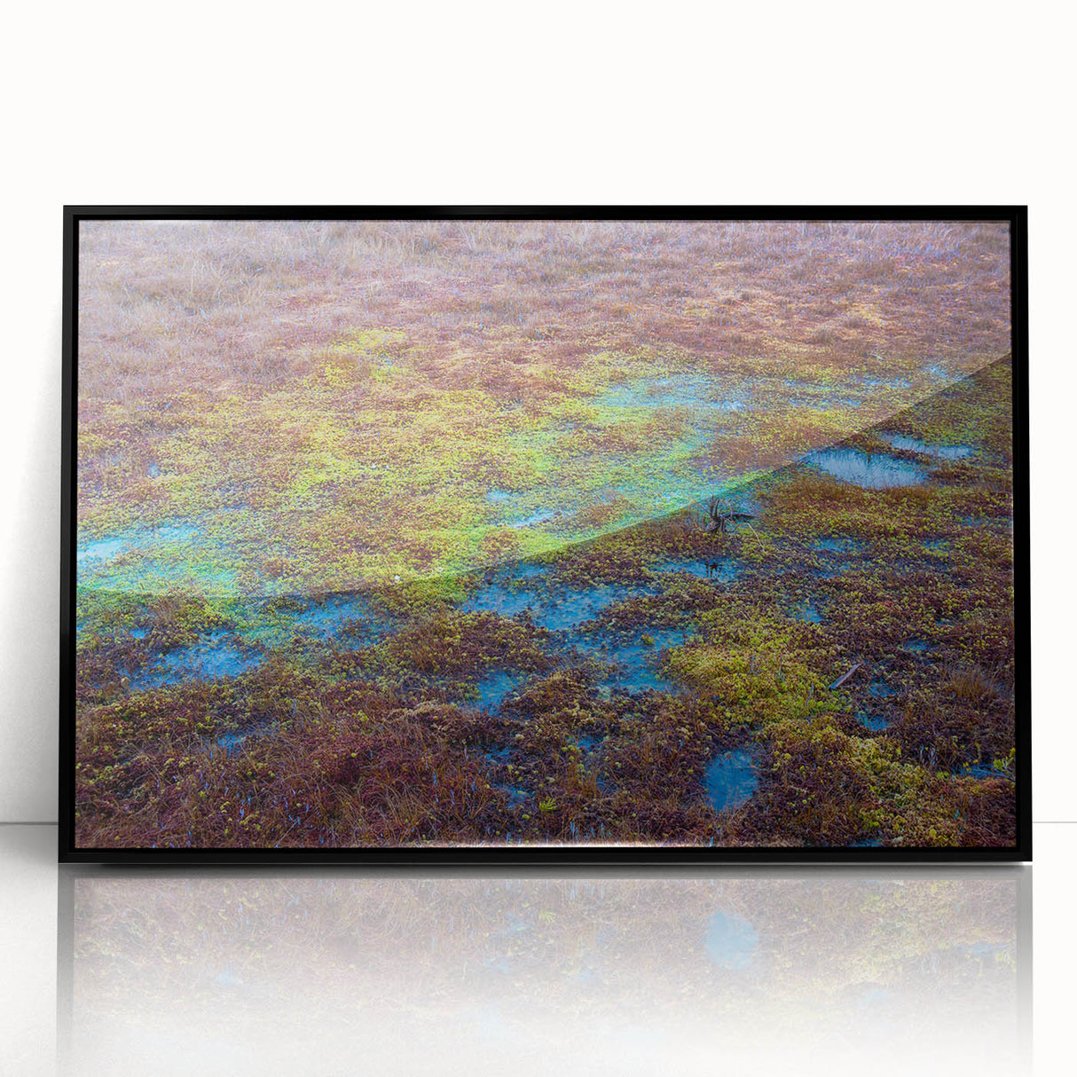 Framed wall art featuring a serene marsh landscape design, with lush greenery and tranquil water reflections, elegantly displayed in a black frame for modern decor.