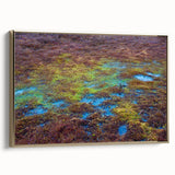 Framed canvas wall art showcasing a serene marsh landscape with lush greenery and water reflections, accented by a gold frame, ideal for nature-inspired decor.