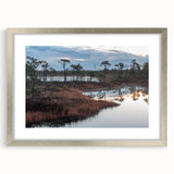 Framed wall art featuring a serene marsh landscape with vibrant greens and blues, designed to enhance home decor. The elegant silver frame complements the natural theme.