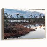 Framed canvas wall art showcasing a tranquil marsh landscape with vibrant greens and blues, accented by a gold frame, perfect for enhancing any home decor.