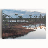 Stretched canvas wall art depicting a serene marsh landscape with vibrant greens and tranquil water reflections, perfect for nature-inspired decor.