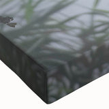 Close-up of a vibrant stretched canvas wall art piece showcasing a serene marsh landscape with lush greenery and tranquil water, perfect for nature-inspired decor.