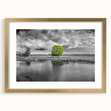 Framed wall art depicting a serene marsh landscape with vibrant greenery and a tranquil swamp setting, featuring a gold frame and mat, ideal for home decor.