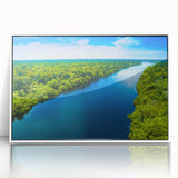 Framed wall art print showcasing a serene marsh landscape with lush greenery and soft clouds, presented in a white frame that enhances its natural beauty, ideal for home decor.