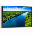 Framed canvas wall art depicting a serene marsh landscape with lush greenery and tranquil water reflections, featuring a sleek black frame for modern decor.