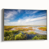 Framed canvas wall art showcasing a serene marsh landscape with lush greenery and reflective water, accented by a silver frame for an elegant touch. Ideal for nature-themed decor.