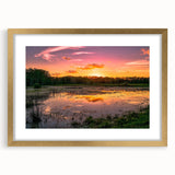 Framed wall art featuring a serene marsh landscape design with a gold mat and frame, showcasing lush greenery and tranquil water reflections, perfect for home decor.