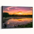 Framed canvas wall art featuring a serene marsh landscape with rich greens and blues, showcasing tranquil water reflections and lush vegetation in a modern black frame. Perfect for nature-themed decor.