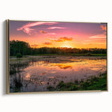 Framed canvas wall art depicting a serene marsh landscape with lush greenery and water reflections, accented by a gold frame, ideal for home decor.