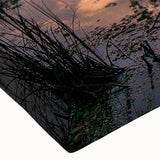 Close-up of a stretched canvas wall art piece showcasing a vibrant marsh landscape with lush greenery and reflective water, ideal for nature-inspired decor.