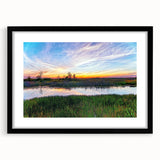 Framed wall art showcasing a serene marsh landscape with lush greenery and soft reflections on water, presented in a sleek black frame with a mat. Perfect for nature lovers seeking tranquil home decor.