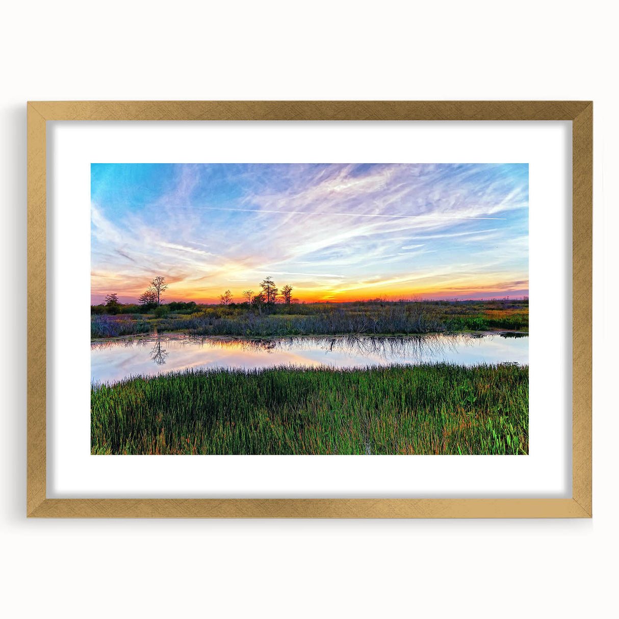 Framed wall art featuring a serene marsh landscape with lush greenery and gentle water reflections, elegantly bordered in gold, perfect for home decor.