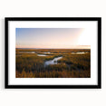 Black-framed wall art featuring a serene marsh landscape with vibrant green wetlands and soft blue skies, perfect for adding a nature-inspired touch to home decor.