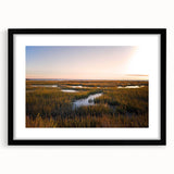 Black-framed wall art featuring a serene marsh landscape with vibrant green wetlands and soft blue skies, perfect for adding a nature-inspired touch to home decor.