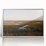 Framed acrylic wall art showcasing a serene marsh landscape, featuring vibrant greens and blues, set against a white frame for a modern aesthetic in home decor.