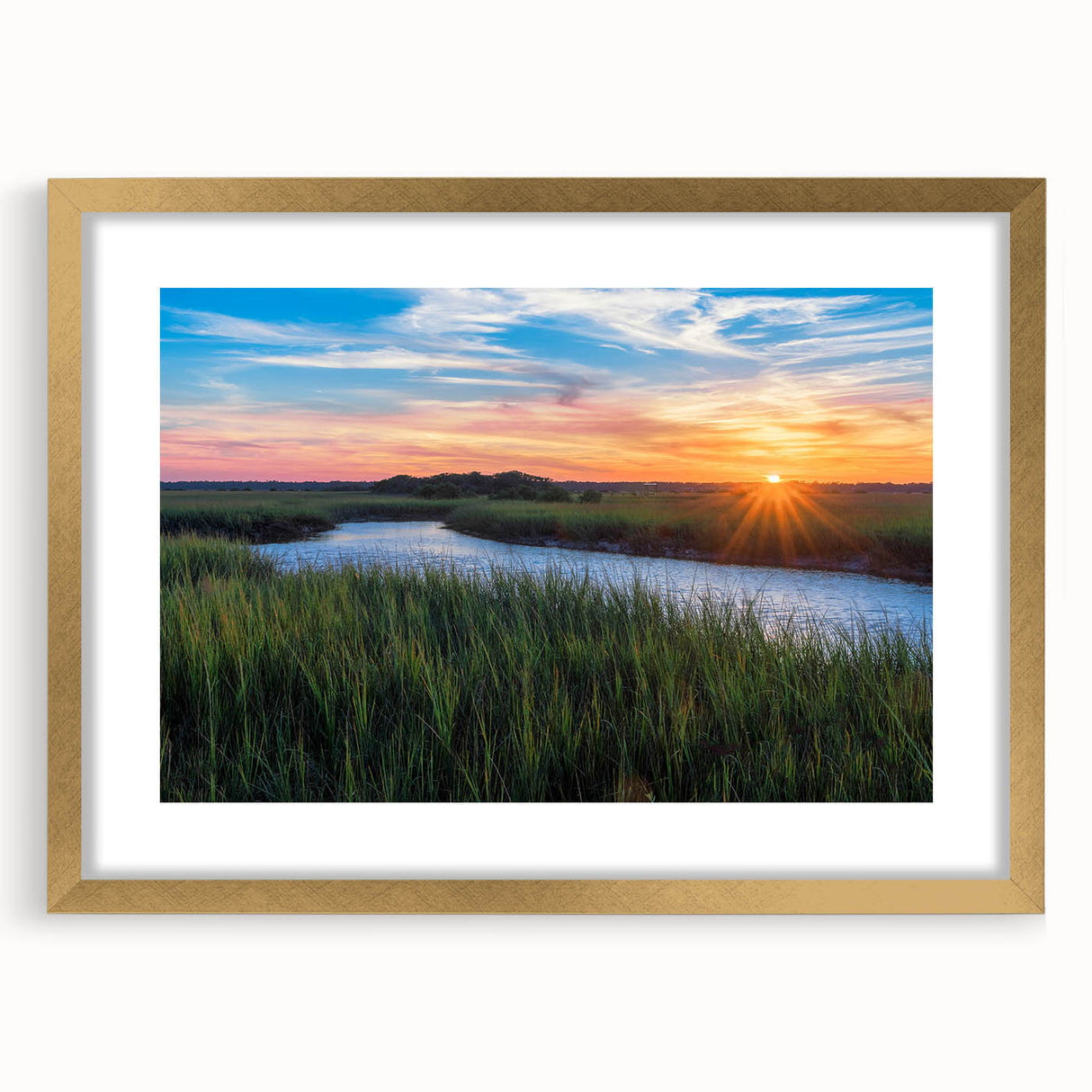 Framed wall art featuring a serene marsh landscape with lush greenery and soft water reflections, enhanced by a gold mat. Perfect for nature-inspired decor.