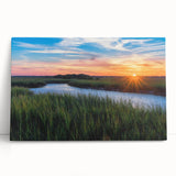Stretched canvas wall art depicting a serene marsh landscape with vibrant green reeds, soft blue water, and a tranquil sky, perfect for nature-themed decor.