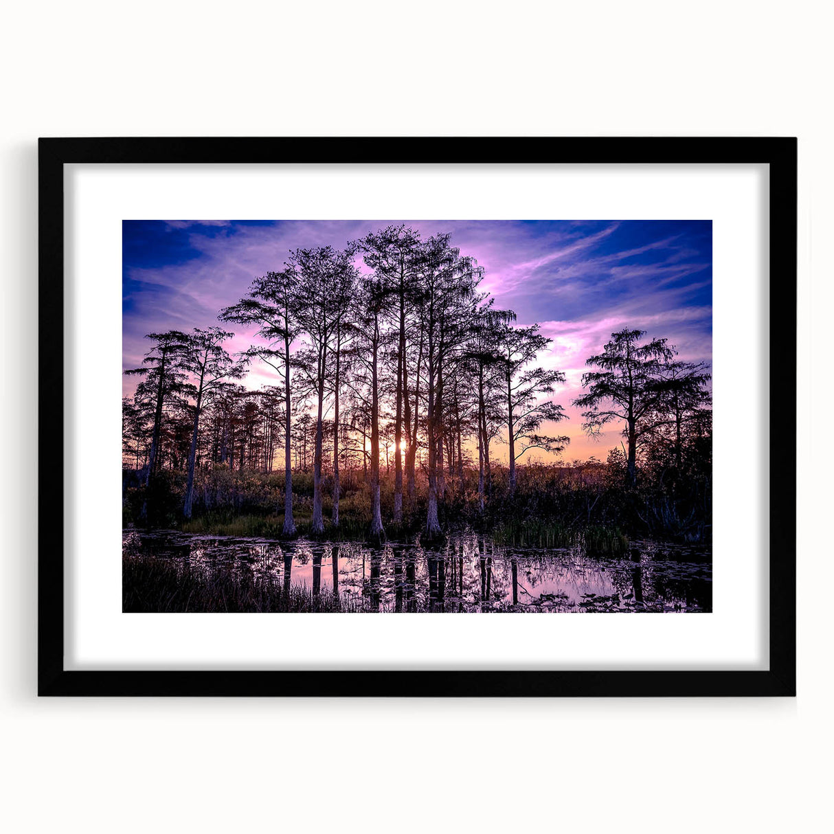 Framed wall art collection showcasing a tranquil marsh landscape, featuring rich greens and blues, with a sleek black frame and white mat. Ideal for nature lovers.