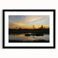 Framed wall art collection featuring a serene marsh landscape with lush greenery and reflective water, set in a sleek black frame with a white mat, perfect for enhancing home decor.