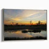 Framed canvas wall art showcasing a serene marsh landscape with vibrant greens and blues, accented by silver framing, ideal for home decor.