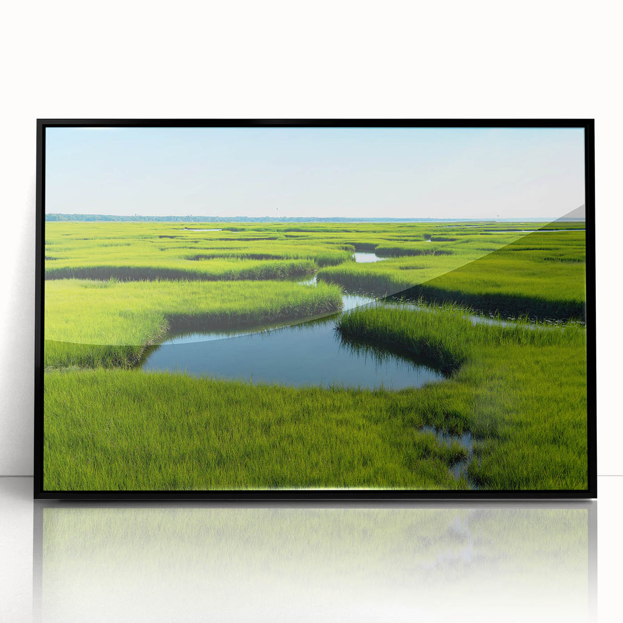 Framed acrylic wall art depicting a serene marsh landscape with vibrant greenery and reflections on water, showcasing nature's tranquility in a black frame.