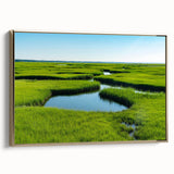 Framed canvas wall art showcasing a serene marsh landscape with vibrant green reeds and a calm water reflection, accented by a gold frame, ideal for nature-themed decor.