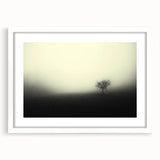 Framed landscape wall art featuring a misty fog design in soft, muted colors, accented by a white mat, ideal for enhancing home decor and creating a serene atmosphere.