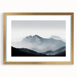 Framed wall art featuring a serene misty landscape with fog, elegantly designed with a gold frame and mat, perfect for enhancing home decor aesthetics.