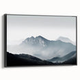 Framed canvas wall art showcasing a serene misty landscape design, featuring soft gray and blue tones, elegantly displayed in a sleek black frame, perfect for home decor.