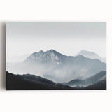 Stretched canvas artwork showcasing a serene landscape shrouded in mist, featuring soft hues of blue and gray, perfect for creating a calming atmosphere in home decor.